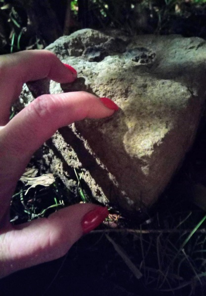 Fingernails grip onto a rock, shadows cast ominously for chasing that high post