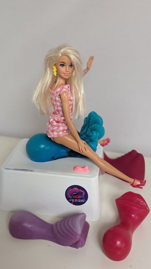 Barbie demonstrating Edinburgh sex toy company Ruby Glow's ride on sex toys and grinders for sexy Christmas blog