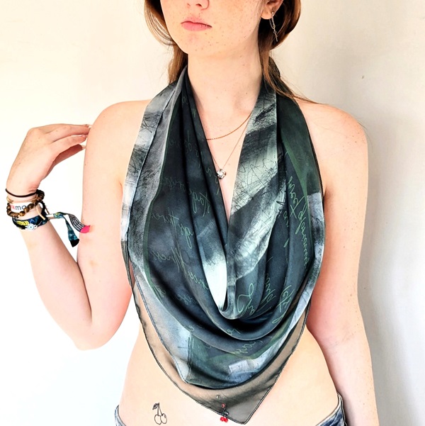 a woman wears a sexy silk scarf draped as a beautiful wispy top