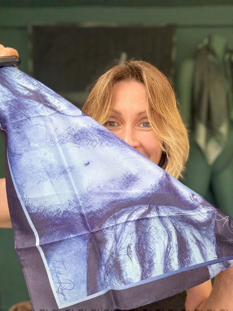 Tabitha Rayne a white scottish woman holds up a blue scarf with a nude on it tastefully folded so as not to offend even during masturbation month we have to watch the censors!